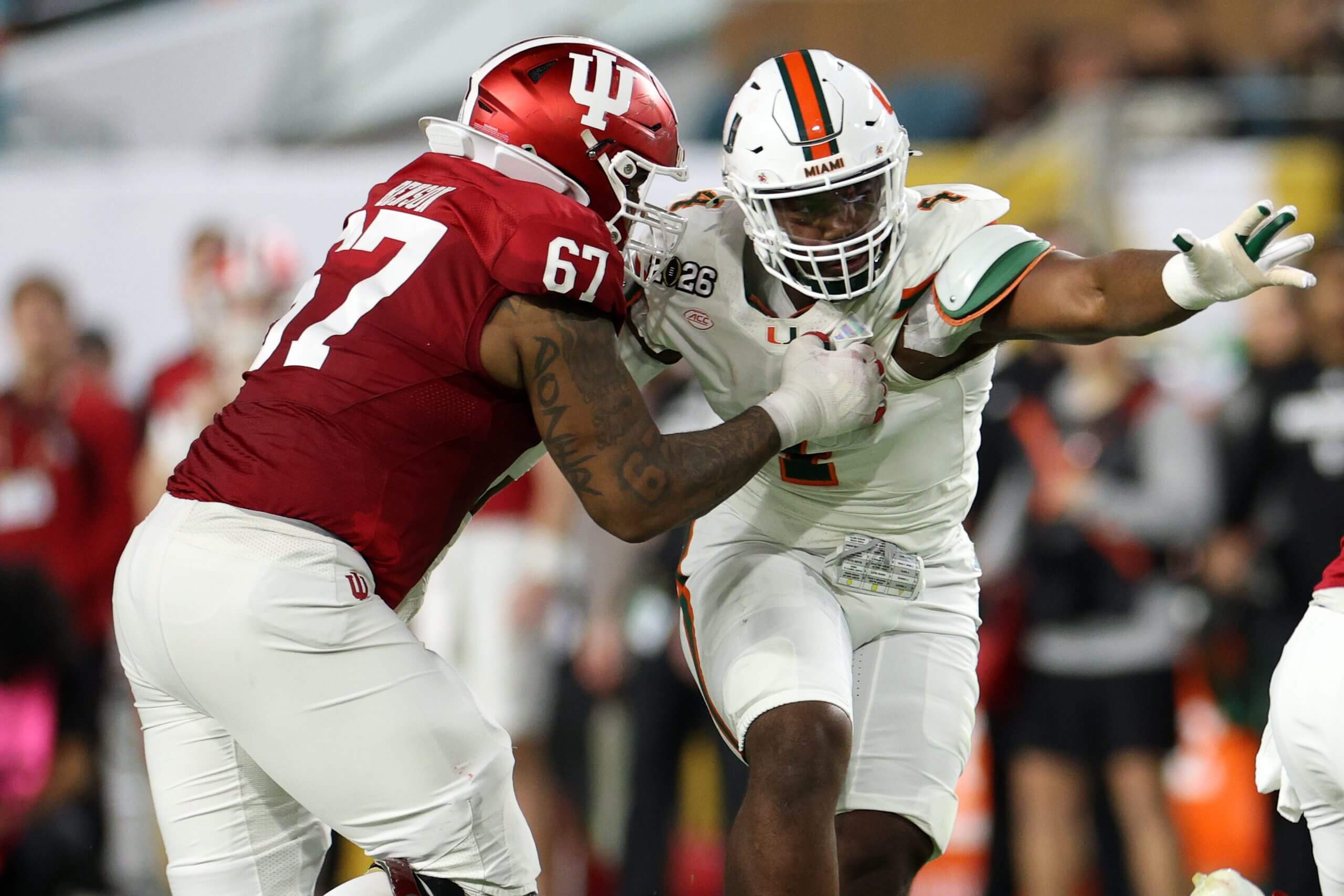 Indiana Hoosiers offensive lineman Kahlil Benson (67) attempts to block Miami Hurricanes defensive lineman Rueben Bain Jr. (4) in the first half during the College Football Playoff National Championship game at Hard Rock Stadium.