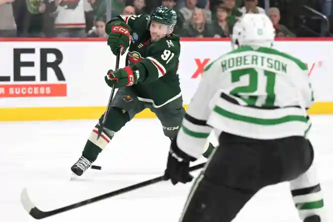 Mar 21, 2026; Saint Paul, Minnesota, USA; Minnesota Wild forward Vladimir Tarasenko (91) scores an overtime game-winning goal as Dallas Stars forward Jason Robertson (21) looks on at Grand Casino Arena. Mandatory Credit: Nick Wosika-Imagn Images