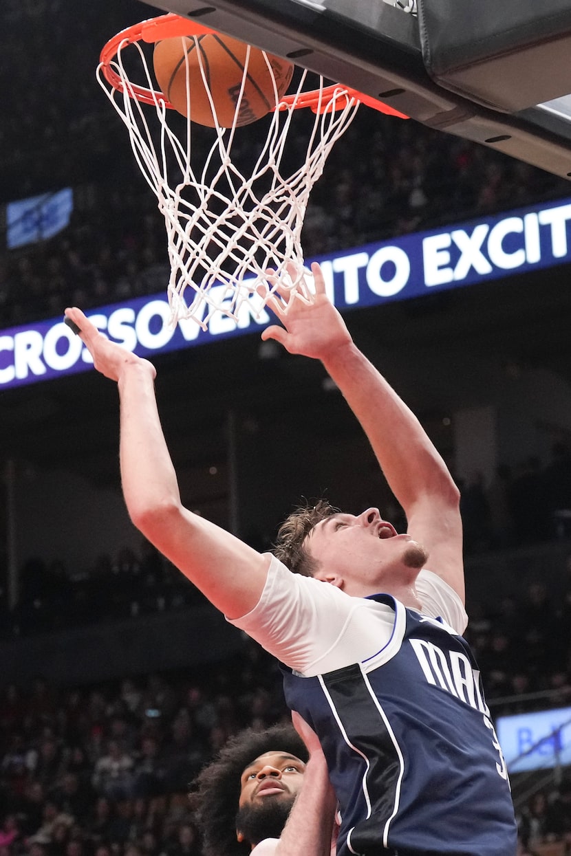 Dallas Mavericks' Cooper Flagg (32) scores during second half NBA basketball action against...