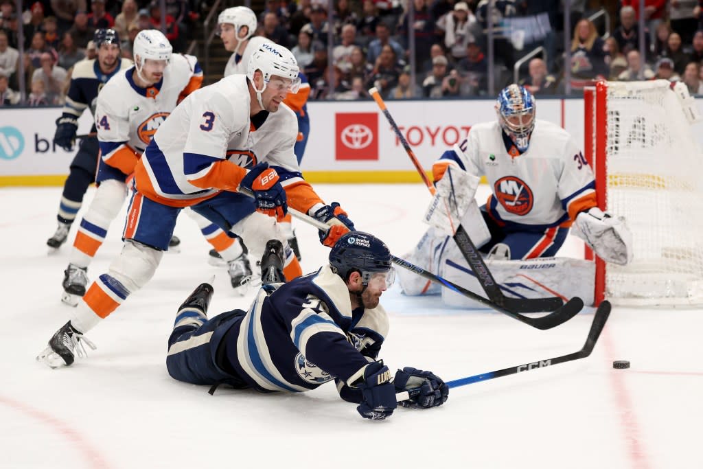 Boone Jenner sweeps the puck back toward Ilya Sorokin during the Islanders’ overtime win over the Blue Jackets. NHLI via Getty Images