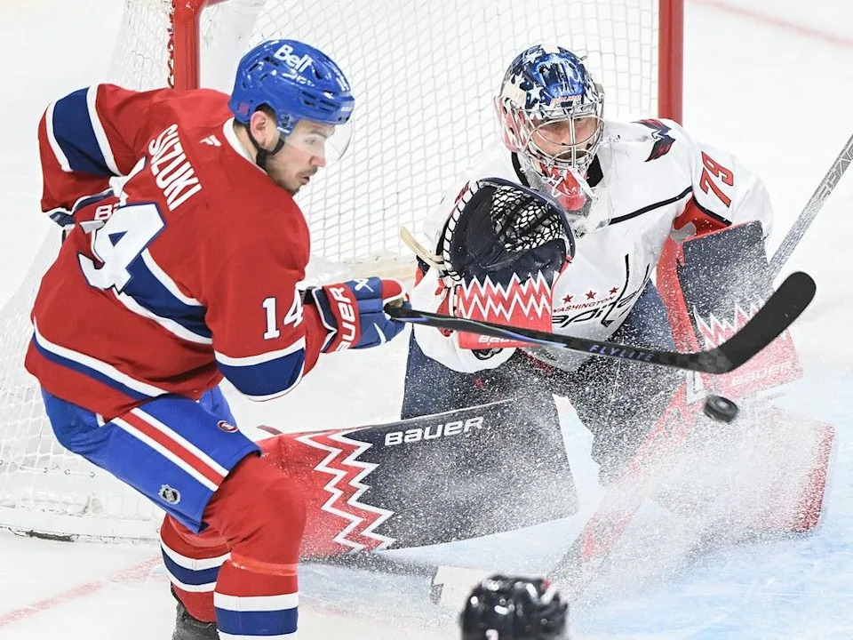  Canadiens’ Nick Suzuki (14) tries to tip the puck past Washington Capitals goaltender Charlie Lindgren in Montreal on Saturday, Feb. 28, 2026.