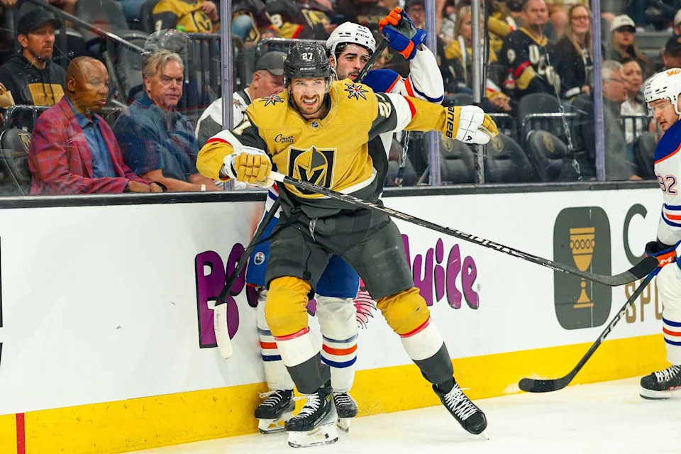 Vegas Golden Knights D Shea Theodore (27) lays a hit during an NHL game against the Edmonton Oilers on Thursday, March 26, 2026, in Las Vegas, Nevada.