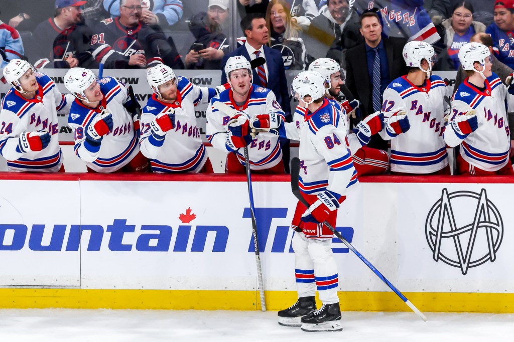 Adam Edstrom #84 of the New York Rangers celebrates his third-period goal with teammates.