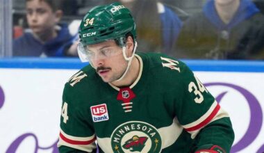 A close-up of Toronto Maple Leafs captain Auston Matthews (#34) in a Minnesota Wild jersey on the ice, appearing focused. Matthews is central to recent blockbuster NHL trade rumors linking him to the Wild.