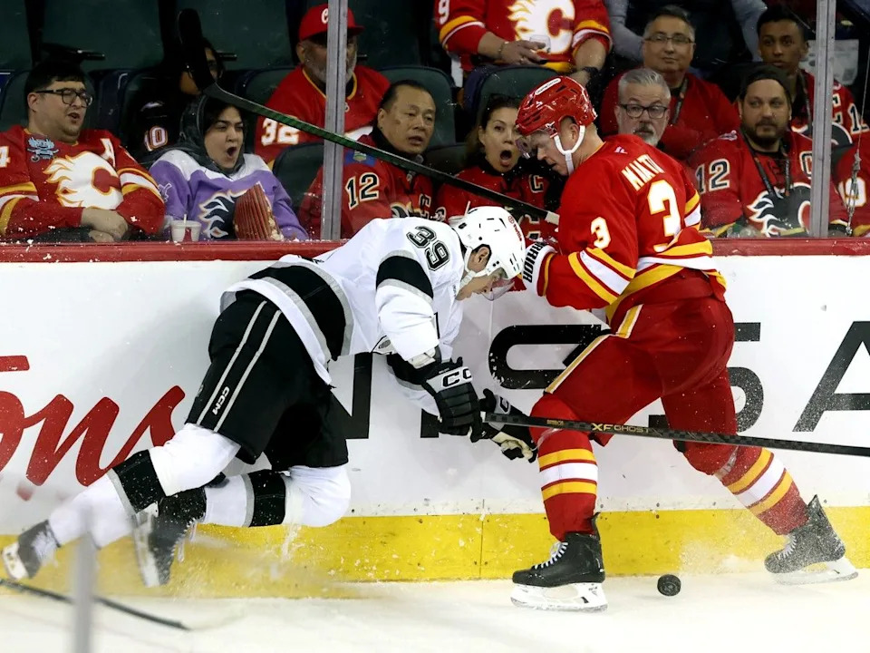  Olli Maatta battles Kings forward Jeff Malott.