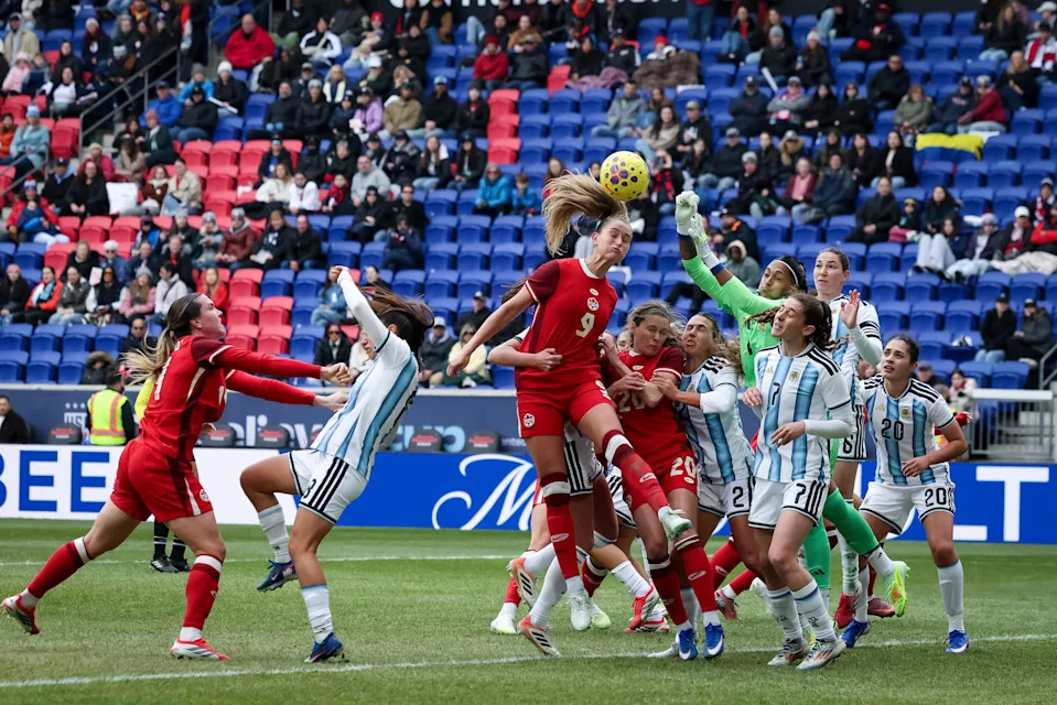 HARRISON, NEW JERSEY - MARCH 7: Solana Pereyra #1 of Argentina jumps to stop a header by Jordyn Huitema #9 of Canada in the second half of the SheBelieves Cup 2026 against Canada at Sports Illustrated Stadium on March 7, 2026 in Harrison, New Jersey. (Photo by Ira L. Black/USSF/Getty Images)