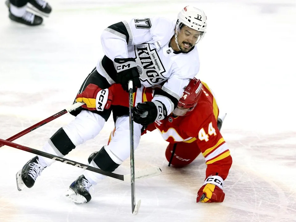  Flames defenceman Joel Hanley battles Kings forward Mathieu Joseph.