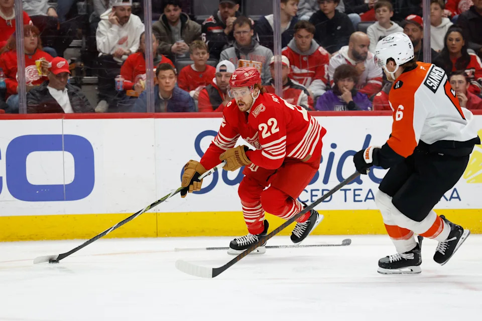 Detroit Red Wings center Mason Appleton (22) skates with the puck defended by Philadelphia Flyers defenseman Travis Sanheim (6) in the second period at Little Caesars Arena in Detroit on Saturday, March 28, 2026.