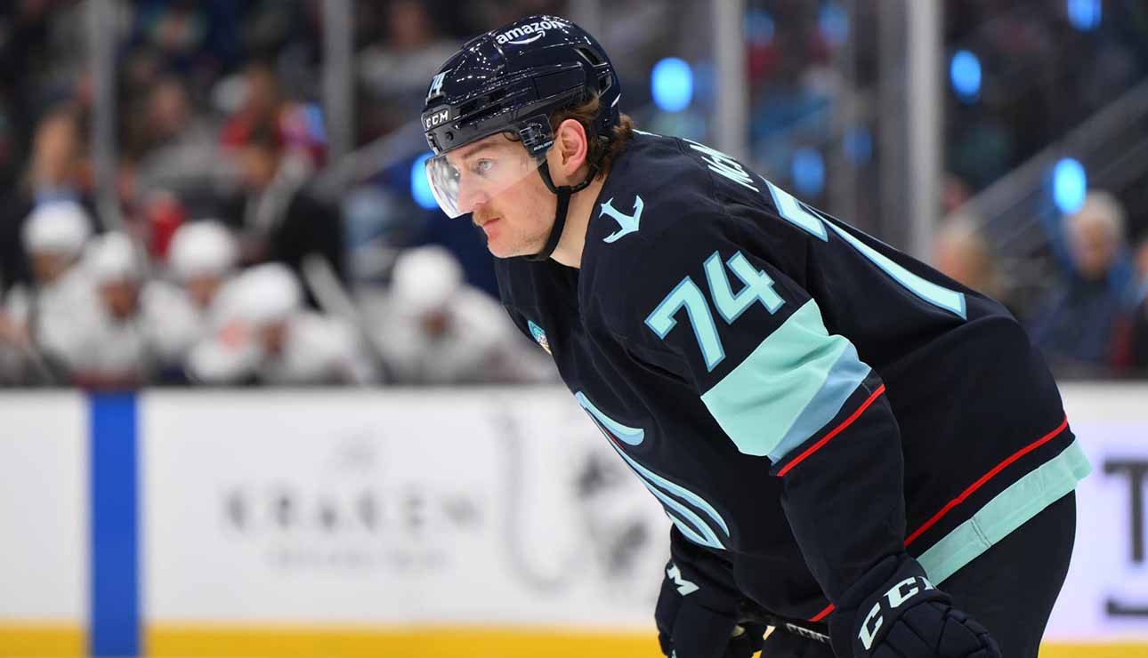 Bobby McMann in a Seattle Kraken jersey getting ready for a faceoff.