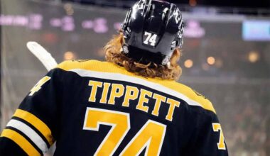 A concept image showing Philadelphia Flyers winger Owen Tippett from behind, wearing a black Boston Bruins number 74 jersey, amidst trade rumors linking him to the team.