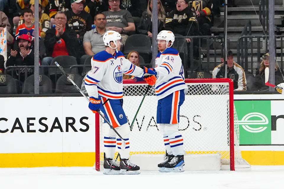 <p>Edmonton Oilers right wing Kasperi Kapanen (42) celebrates with center Connor McDavid (97) after scoring an empty net goal against the Vegas Golden Knights at T-Mobile Arena. Credit: Stephen R. Sylvanie-Imagn Images</p>