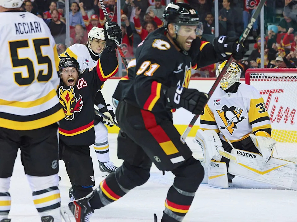  Calgary Flames forwards Blake Coleman and Nazem Kadri celebrate after Kadri scored the tying goal to send the game into overtime against the Pittsburgh Penguins at the Scotiabank Saddledome in Calgary on Tuesday, Oct. 22, 2024.