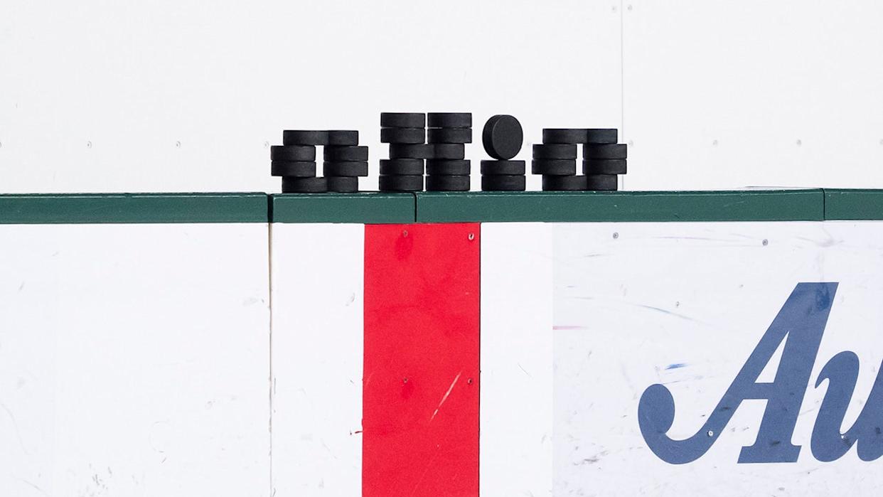 Pucks lined up on the boards