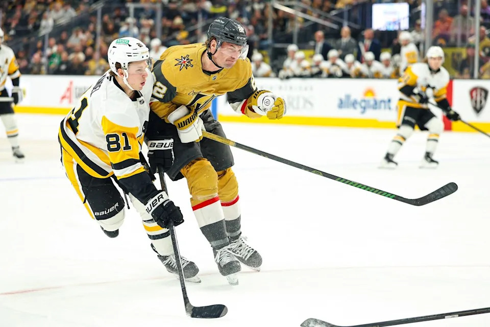 Vegas Golden Knights RW Cole Smith (22) hits Pittsburgh Penguins C Ben Kindel (81) during an NHL game on Thursday, March 12, 2026, in Las Vegas, Nevada. 