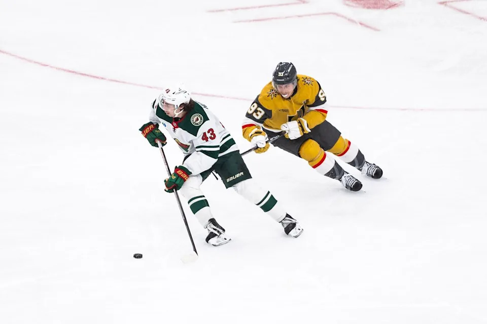 Minnesota Wild defenseman Quinn Hughes (43) skates with the puck as Vegas Golden Knights right-wing Mitch Marner (93) follows him during a NHL game between the Vegas Golden Knights and the Minnesota Wild, Friday March 6, 2026 in Las Vegas, Nev.