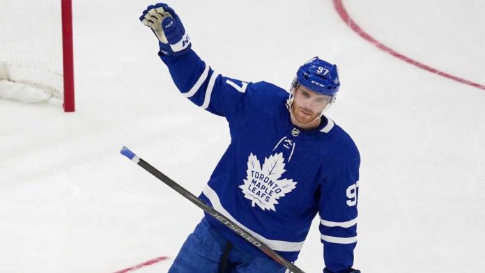 View of superstar Connor McDavid wearing a Toronto Maple Leafs away jersey with number 97, illustrating potential future NHL trade rumors and free agency speculation.