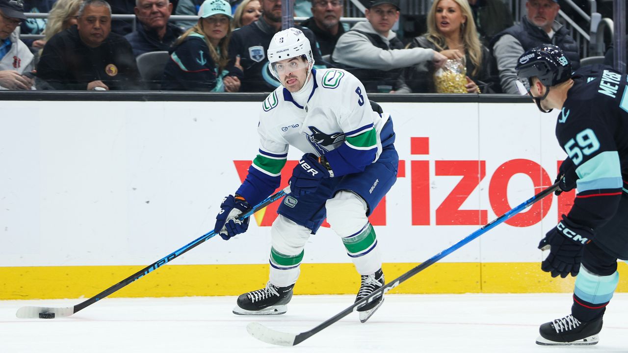 Vancouver Canucks right wing Conor Garland (8) looks to pass in the second period against the Seattle Kraken during an NHL hockey game Saturday, Feb. 28, 2026, in Seattle. (AP Photo/Kevin Ng)