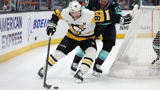 Sidney Crosby #87 of the Penguins skates against Ryan Lindgren #55 of the Kraken. Steph Chambers/Getty Images