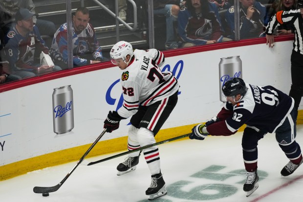 Chicago Blackhawks defenseman Alex Vlasic (72) and Colorado Avalanche left wing Gabriel Landeskog (92) in the first period of an NHL hockey game Saturday, Feb. 28, 2026, in Denver. (AP Photo/David Zalubowski)