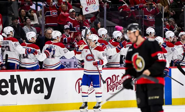 Montreal Canadiens' Alexandre Texier (85) celebrates his goal on Ottawa Senators' goaltender Linus Ullmark with teammates during the second period of an NHL hockey game in Ottawa, Ontario, Wednesday, March 11, 2026. (Spencer Colby/The Canadian Press via AP)