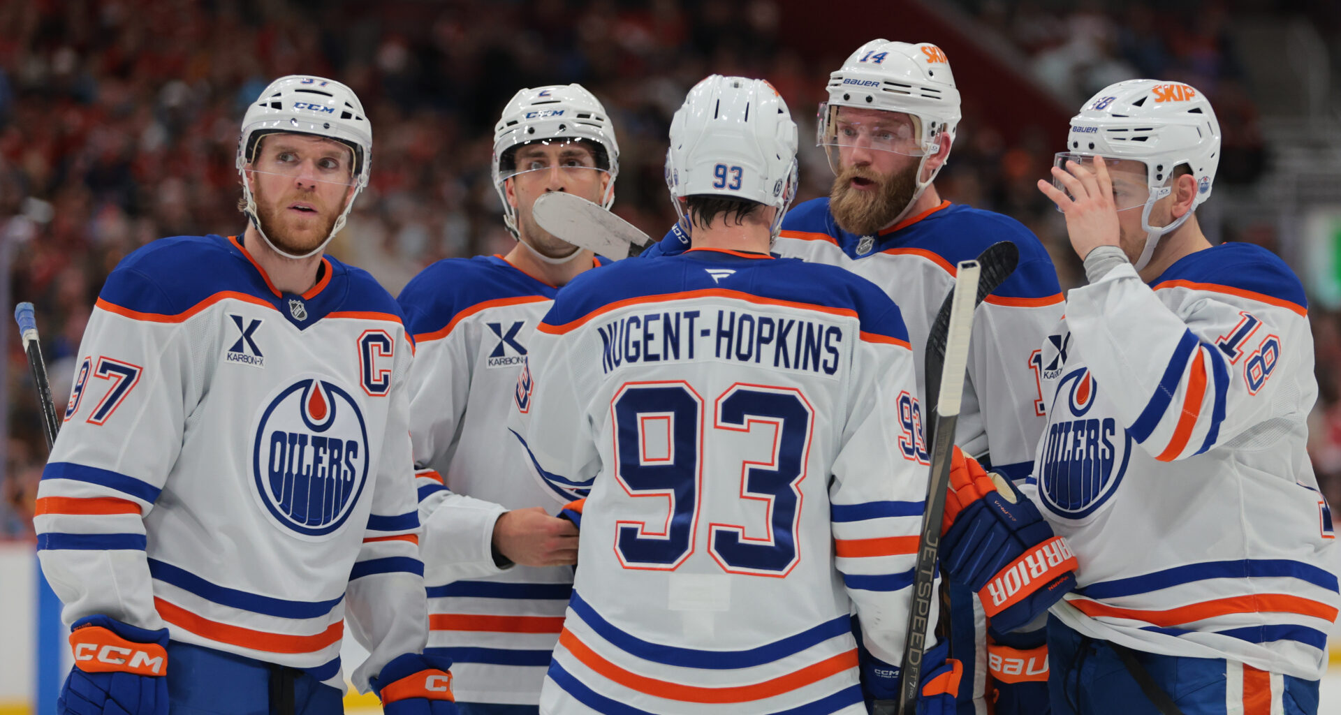Edmonton Oilers defenseman Mattias Ekholm (14) talks to center Connor McDavid (97), defenseman Evan Bouchard (2), center Ryan Nugent-Hopkins (93) and left wing Zach Hyman (18) during the first period at Amerant Bank Arena