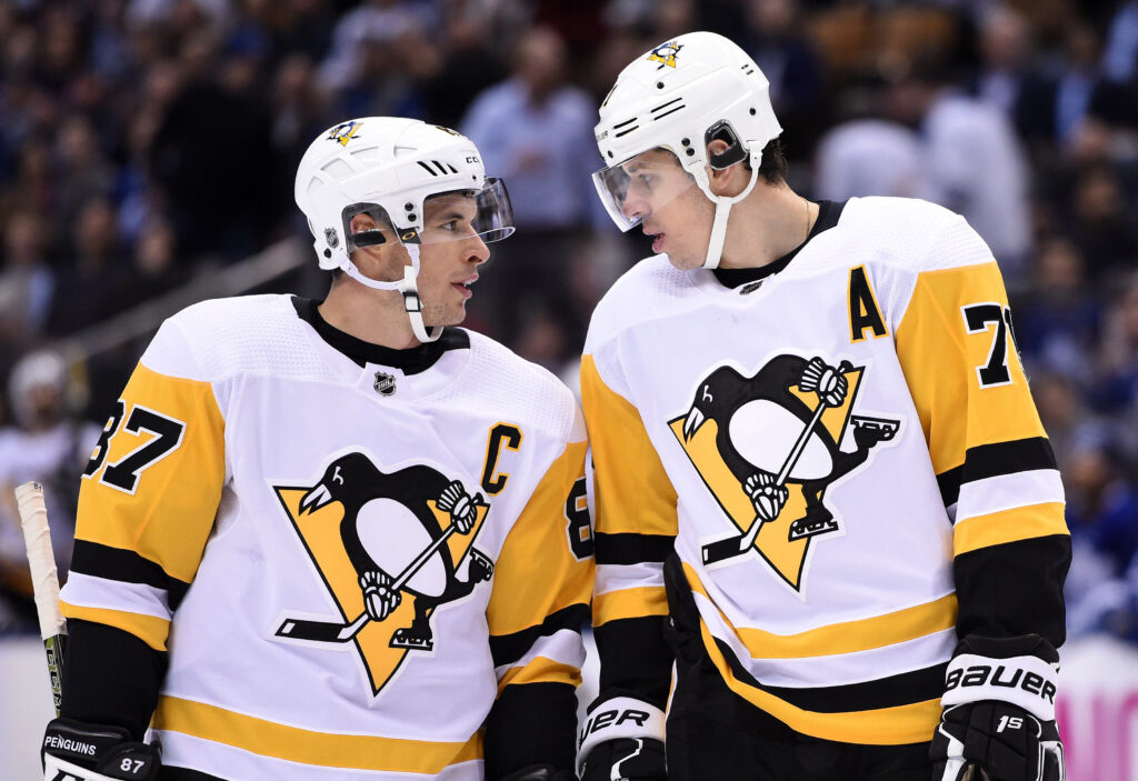 Pittsburgh Penguins forward Sidney Crosby (87) speaks to forward Evgeni Malkin at Scotiabank Arena.