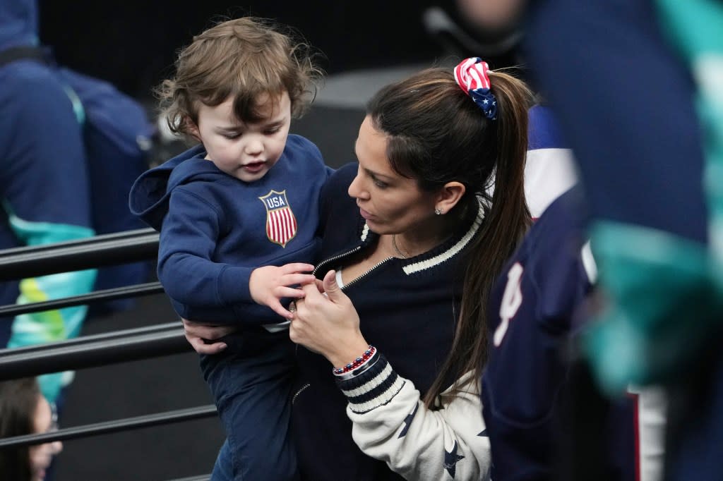 Johnny Gaudreau’s wife, Meredith, holding son Johnny Jr. after Team USA’s gold medal win on Feb. 22, 2026. James Lang-Imagn Images