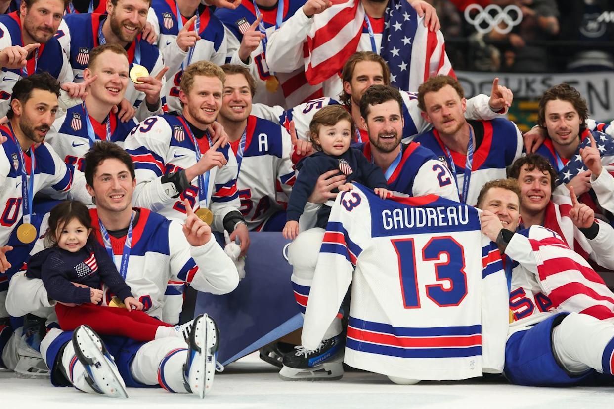 Team USA hockey players pose with a Gaudreau jersey and Johnny Gaudreau's two children at the 2026 Winter OlympicsCredit: Gregory Shamus/Getty