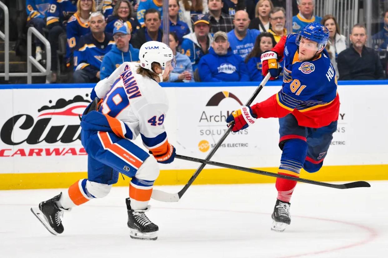 An image collage containing 1 images, Image 1 shows Dylan Holloway shoots and scores as Max Shabanov defends during the Islanders' win overt the Blues on March 10, 2026