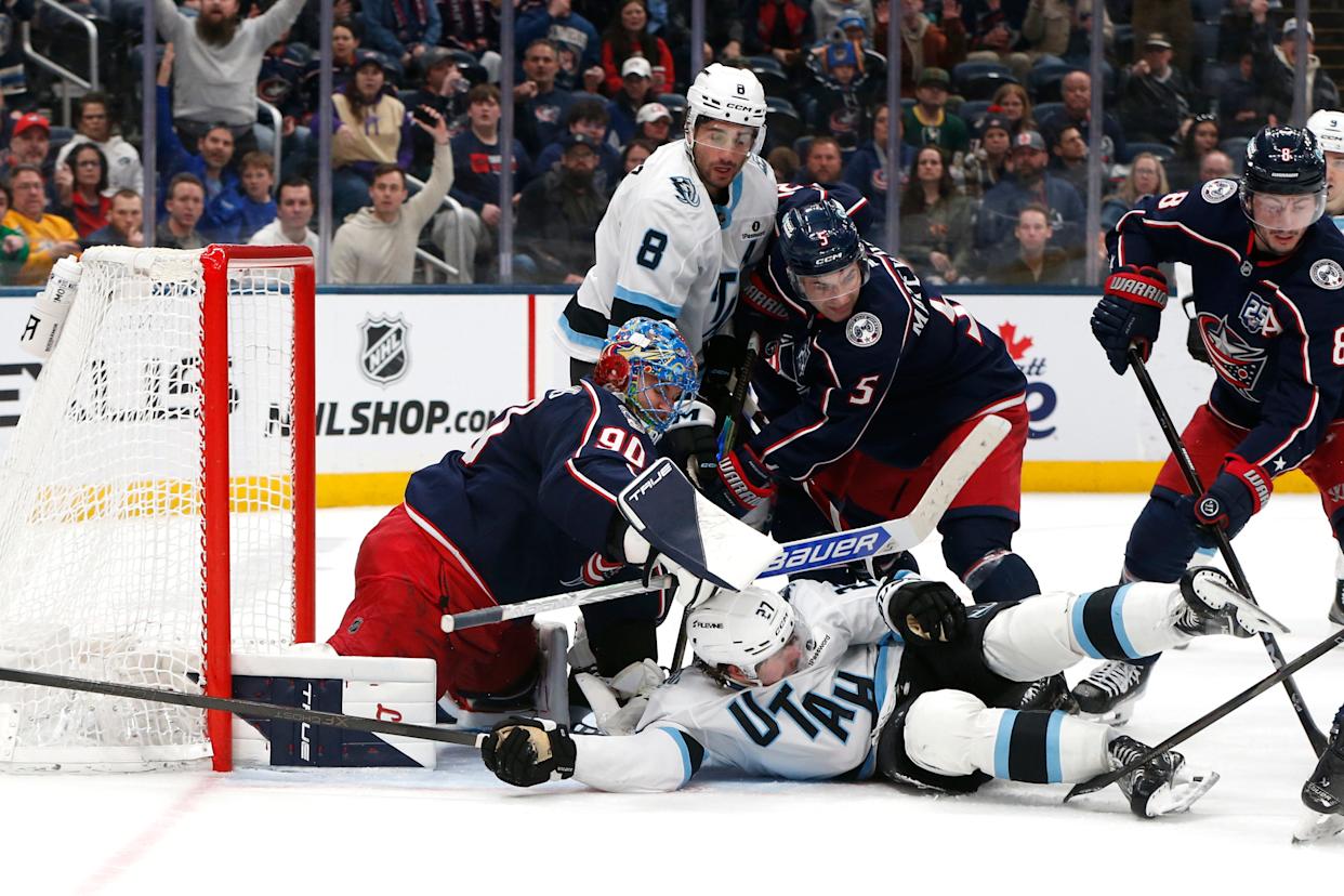 Mar 7, 2026; Columbus, Ohio, USA; Columbus Blue Jackets goalie Elvis Merzlikins (90) sticks Utah Mammoth center Barrett Hayton (27) out of the crease during the third period at Nationwide Arena. Mandatory Credit: Russell LaBounty-Imagn Images
