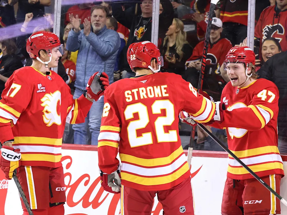  Calgary Flames forward Connor Zary, right, smiles as celebrates his goal on the St. Louis Blues with teammates forward Yegor Sharangovich during NHL action at the Scotiabank Saddledome in Calgary on Wednesday, March 18, 2026.Gavin Young/Postmedia
