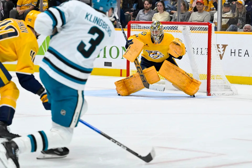 Mar 24, 2026; Nashville, Tennessee, USA; Nashville Predators goaltender Juuse Saros (74) blocks the shot of San Jose Sharks defenseman John Klingberg (3) during the second period at Bridgestone Arena. Mandatory Credit: Steve Roberts-Imagn Images