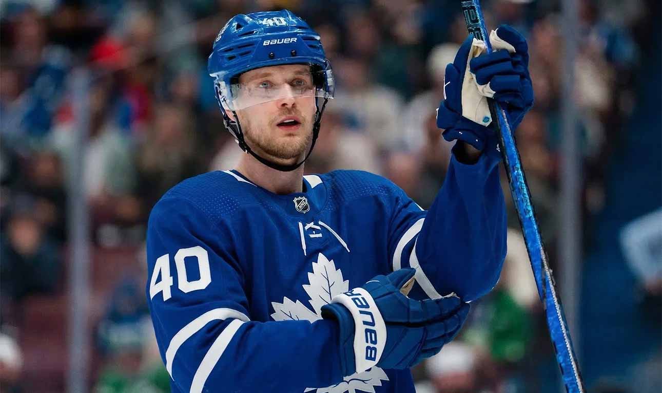 A jersey swap photo illustration of Elias Pettersson wearing a Toronto Maple Leafs home uniform, visually representing the rumored blockbuster trade from the Vancouver Canucks.