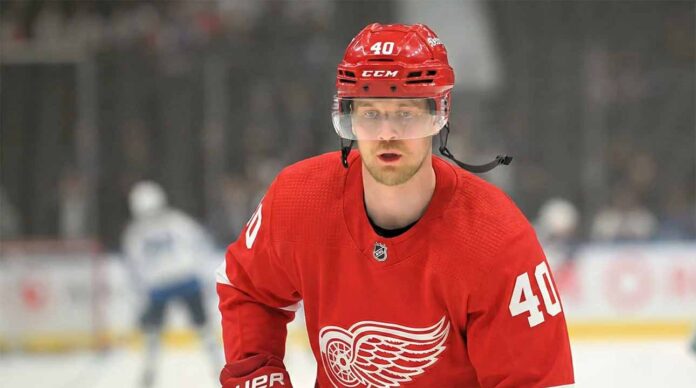 A concept illustration showing current Vancouver Canucks center Elias Pettersson on the ice, wearing a red Detroit Red Wings #40 home jersey and helmet, visualizing recent NHL trade rumors linking the superstar to Detroit.