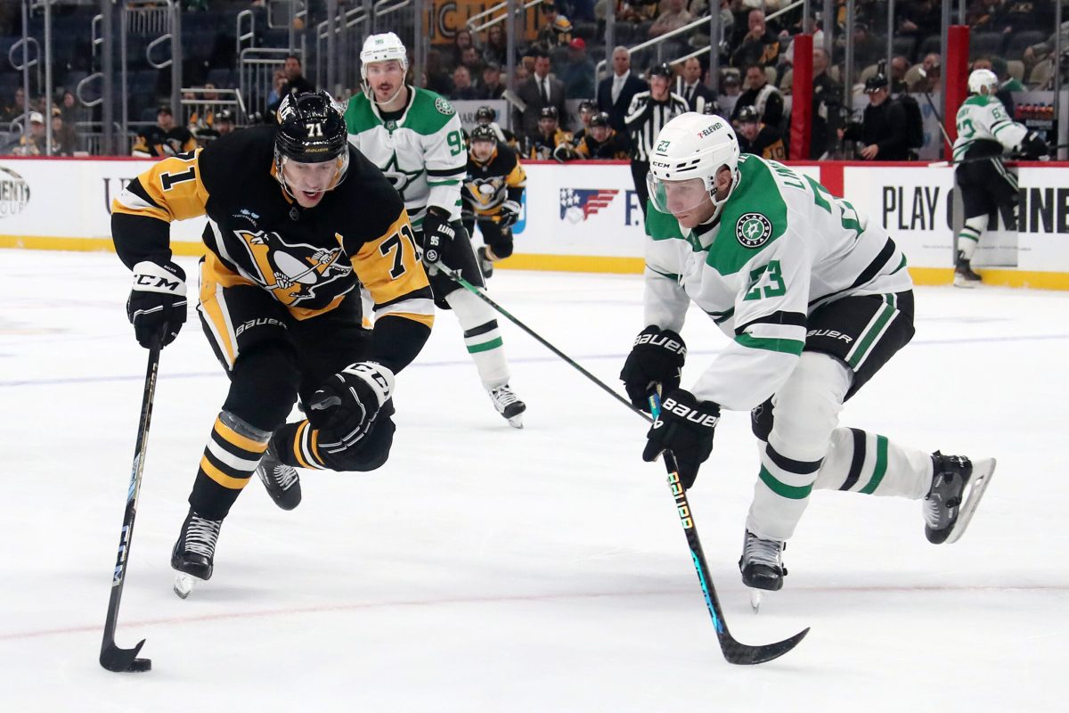 Nov 11, 2024; Pittsburgh, Pennsylvania, USA; Pittsburgh Penguins center Evgeni Malkin (71) moves the puck against Dallas Stars defenseman Esa Lindell (23) during the third period at PPG Paints Arena. Mandatory Credit: Charles LeClaire-Imagn Images