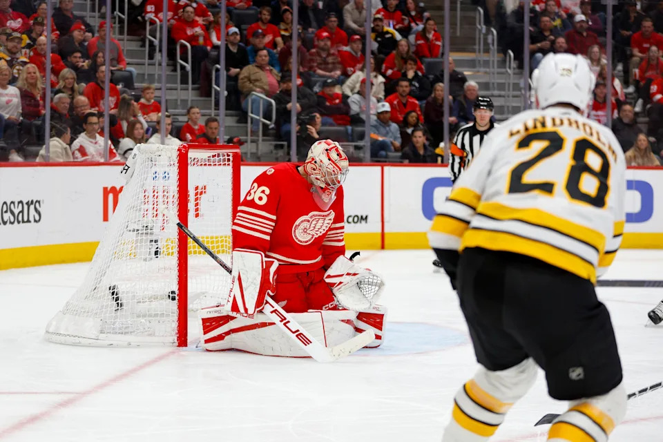 Boston Bruins center Elias Lindholm (28) scores a goal on Detroit Red Wings goaltender John Gibson (36) during the third period at Little Caesars Arena in Detroit on Saturday, March 21, 2026.