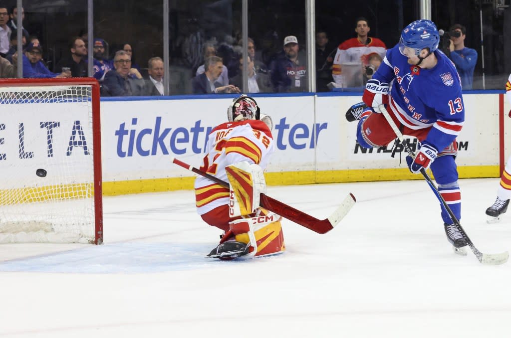 Alexis Lafrenière tips a puck past Dustin Wolf for the first of his three goals in the Rangers’ 4-0 win over the Flames at the Garden on March 10, 2026. Charles Wenzelberg / New York Post