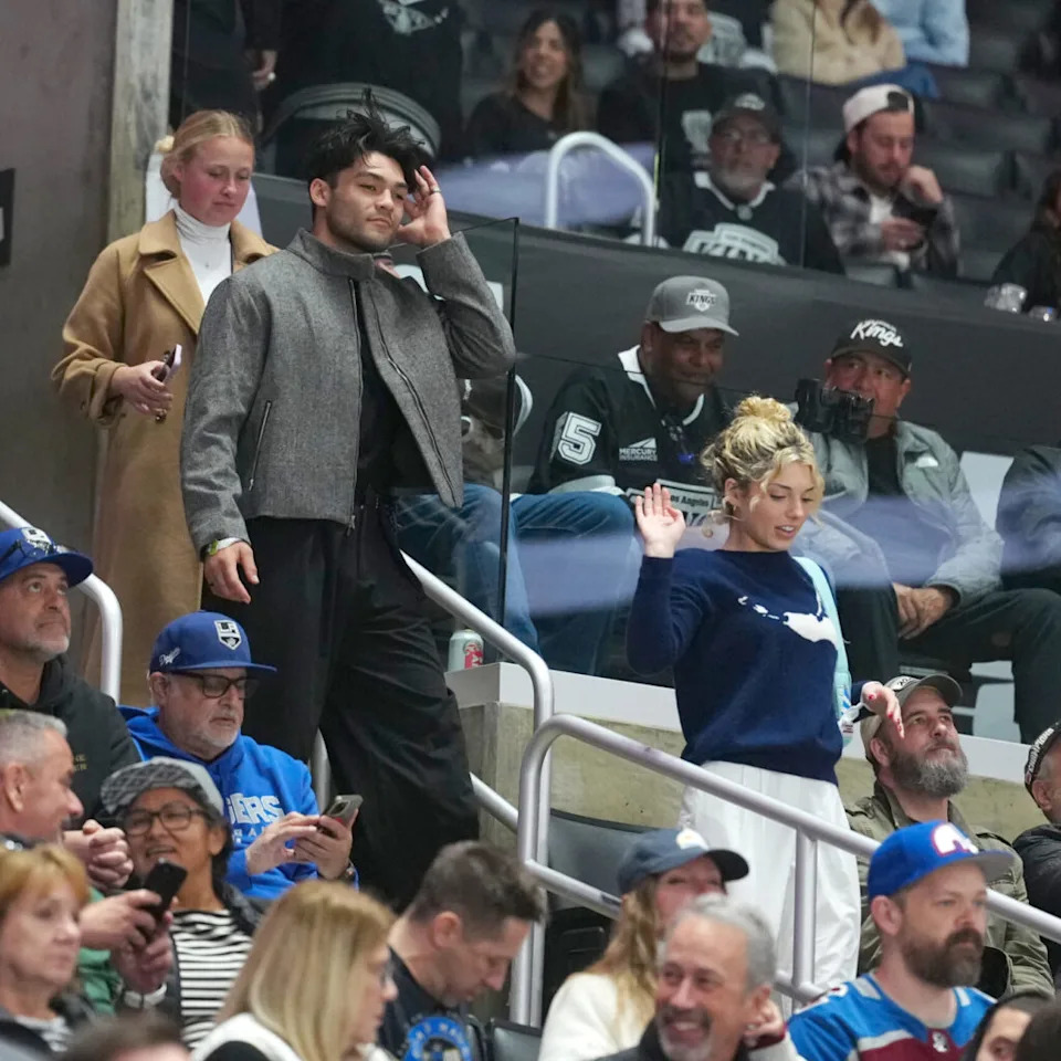 Mar 2, 2026; Los Angeles, California, USA; Los Angeles Rams receiver Puka Nacua (left) and Megan Eugenio aka Overtime Megan watch in the third period of the game between the Colorado Avalanche and the LA Kings at Crypto.com Arena. Mandatory Credit: Kirby Lee-Imagn Images
