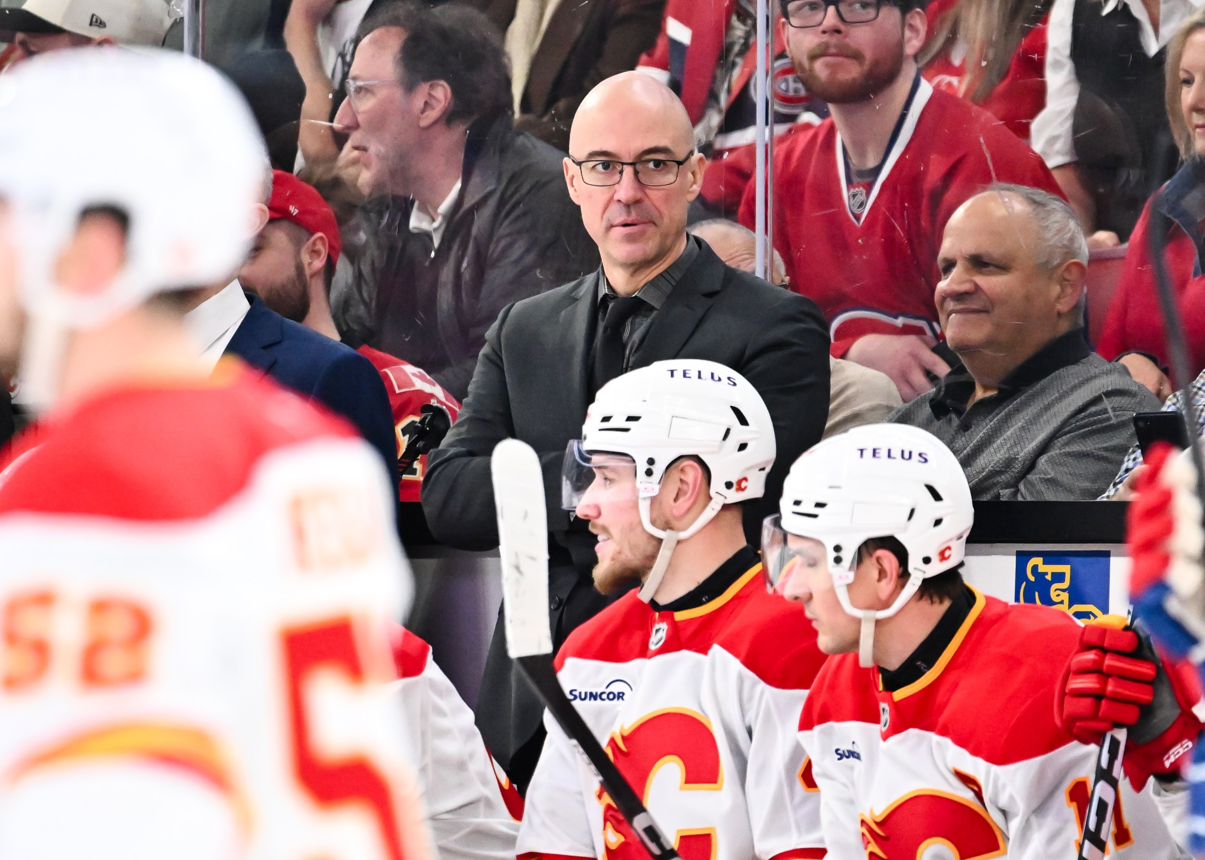 MONTREAL, CANADA - JANUARY 07: Head coach Ryan Huska of the Calgary Flames handles bench duties during the second period against the Montréal Canadiens at the Bell Centre on January 7, 2026 in Montreal, Quebec, Canada. The Montréal Canadiens defeated the Calgary Flames 4-1. (Photo by Minas Panagiotakis/Getty Images)