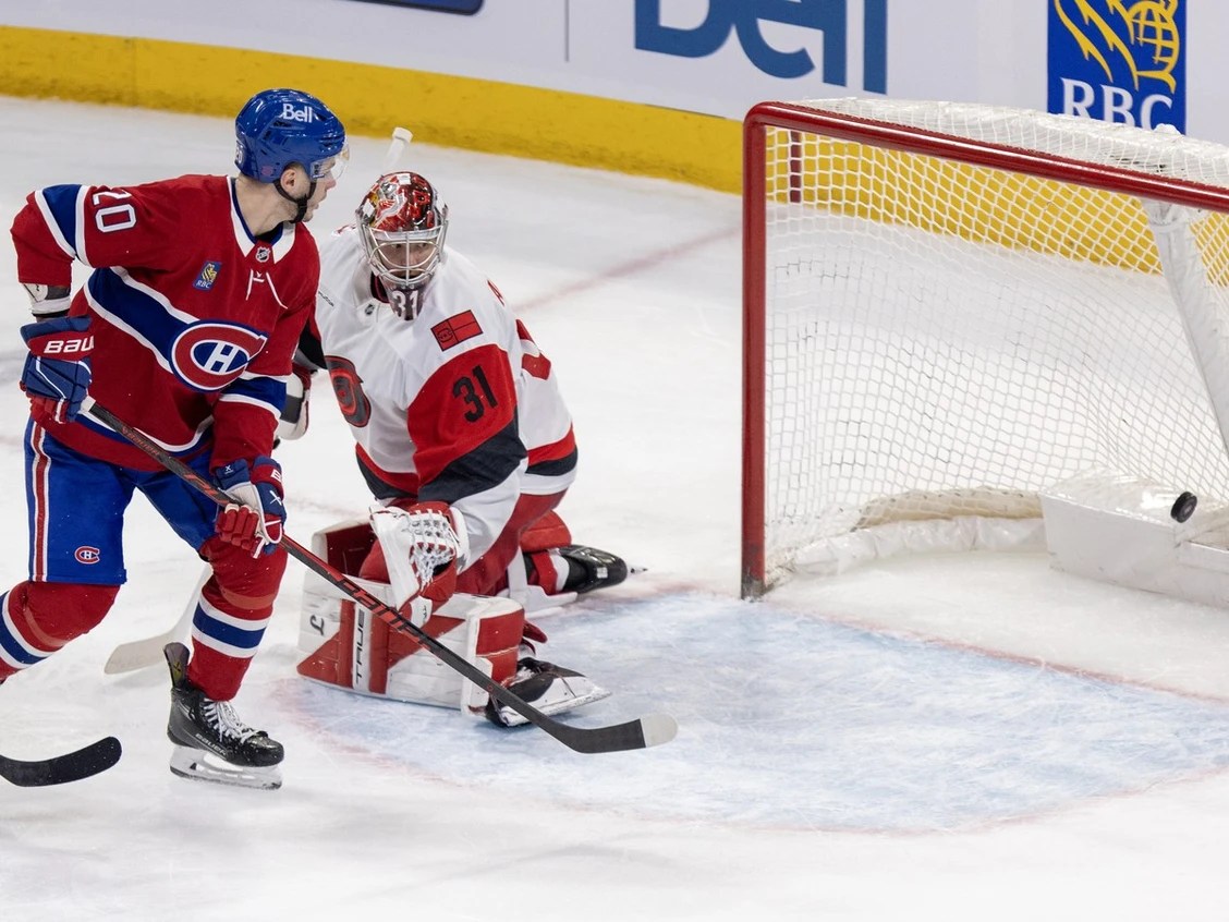 Canadiens’ Juraj Slafkovsky tips a shot past Carolina Hurricanes’ Frederik Andersen