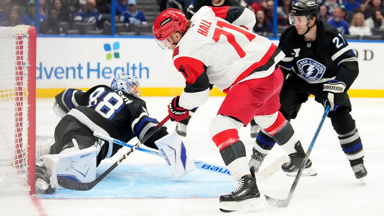 Tampa Bay Lightning goaltender Andrei Vasilevskiy (88) makes a save on a shot by Carolina Hurricanes left wing Taylor Hall (71) during an NHL hockey game Saturday, March 14, 2026, in Tampa, Fla. (AP Photo/Chris O'Meara)