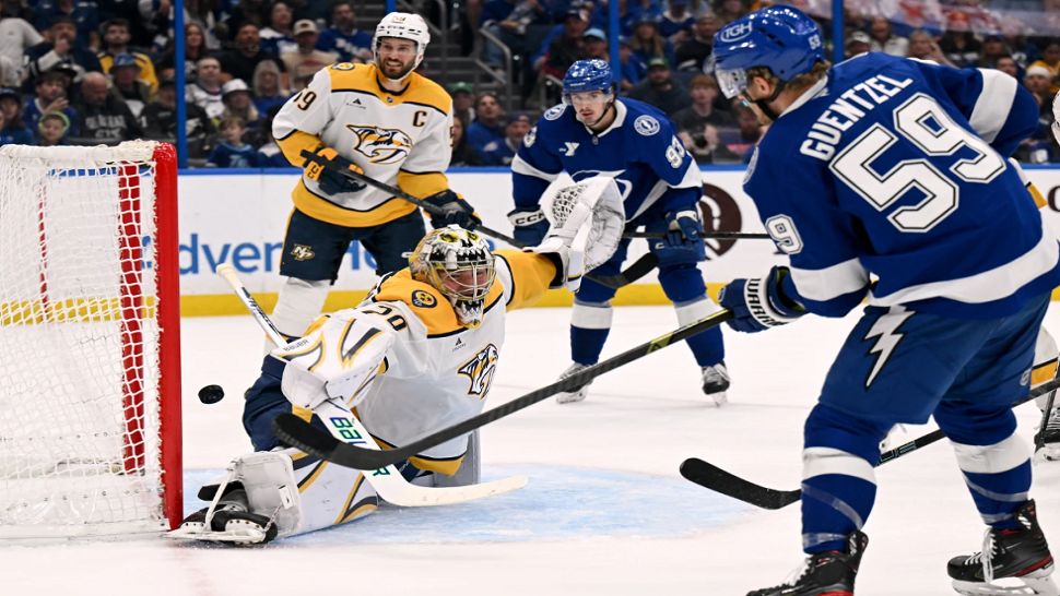Tampa Bay Lightning center Jake Guentzel (59) scores on Nashville Predators goaltender Justus Annunen (29) during the second period of an NHL hockey game, Sunday, March 29, 2026, in Tampa, Fla. (AP Photo/Jason Behnken)
