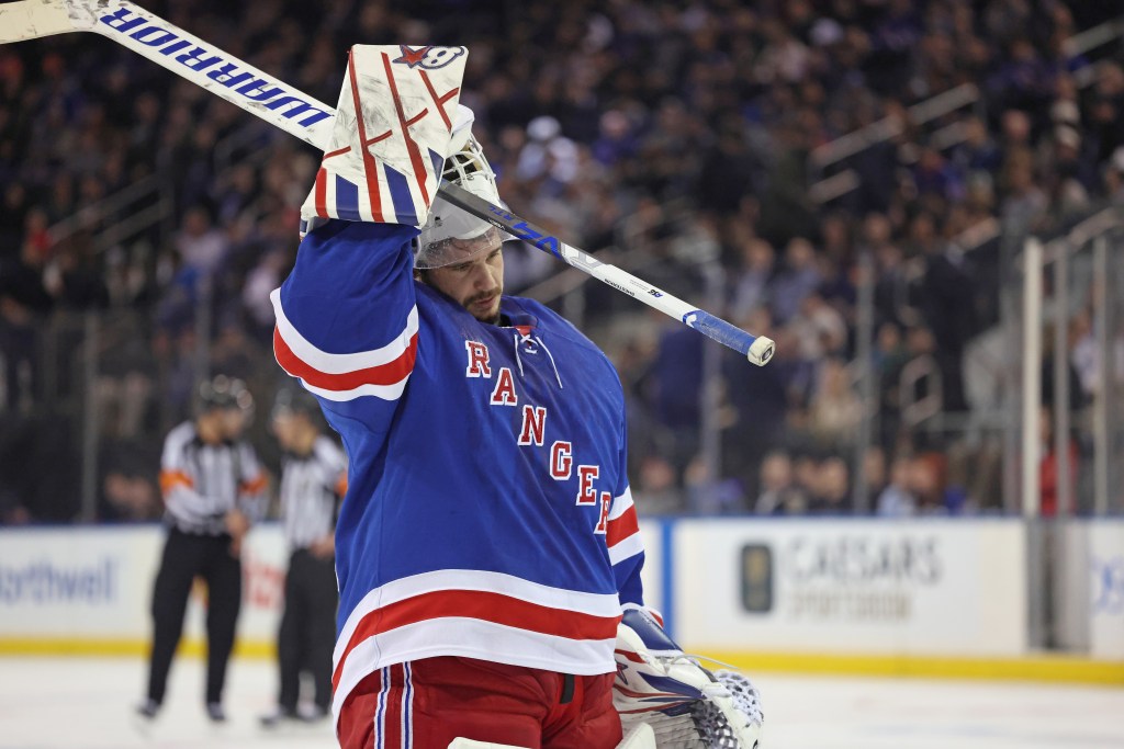 New York Rangers goaltender Igor Shesterkin looking downcast after allowing a goal.