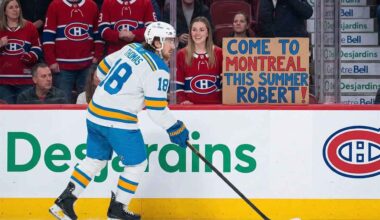 St. Louis Blues player Robert Thomas skates as a Montreal Canadiens fan holds a homemade sign saying "COME TO MONTREAL THIS SUMMER ROBERT!", fueled by persistent Canadiens NHL trade rumors.