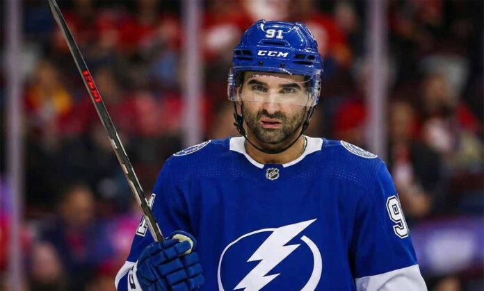 Calgary Flames center Nazem Kadri (91) wears a Tampa Bay Lightning jersey and helmet.