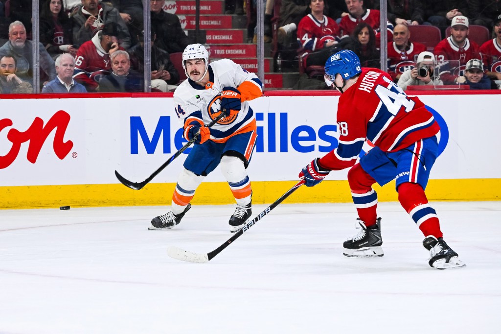 New York Islanders center Jean-Gabriel Pageau (44) shoots the puck against Montreal Canadiens defenseman Lane Hutson (48).