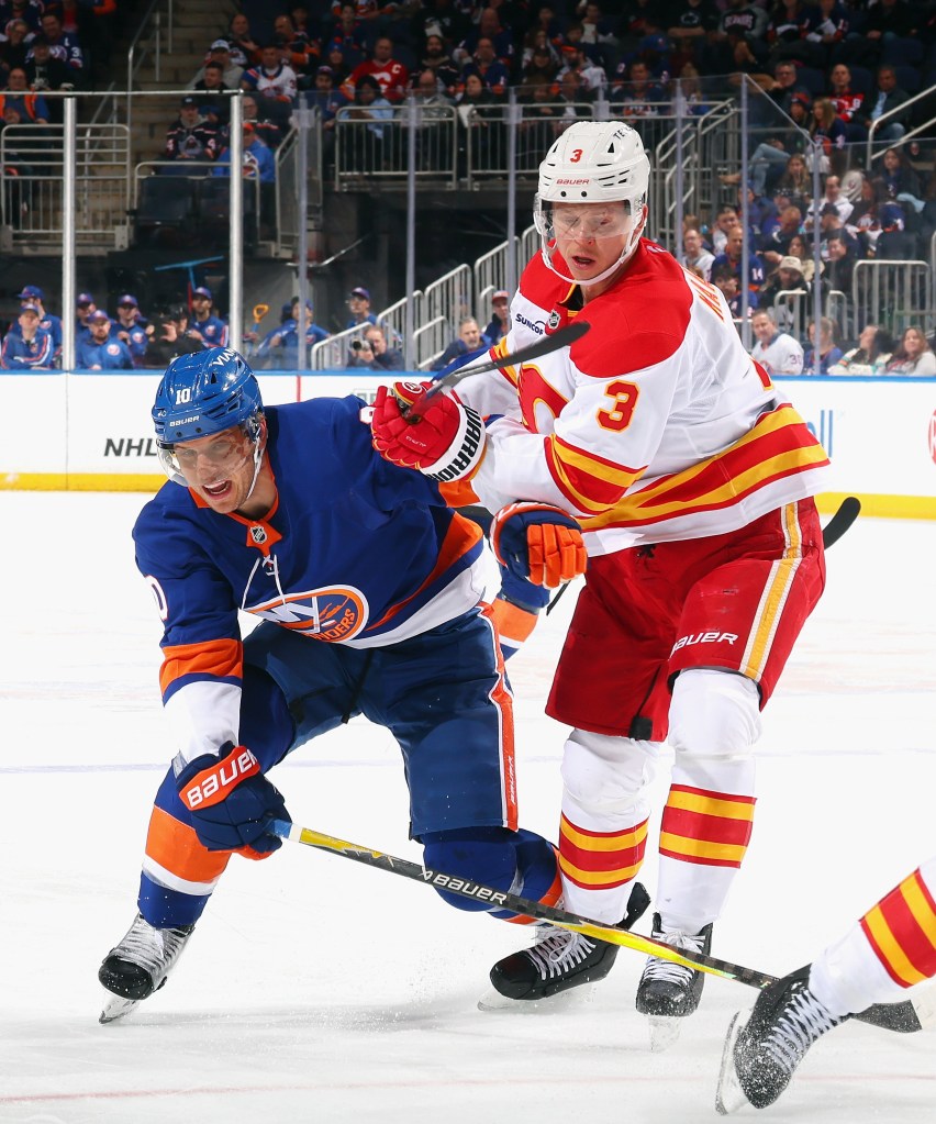 Olli Määttä of the Calgary Flames defends against Brayden Schenn of the New York Islanders.