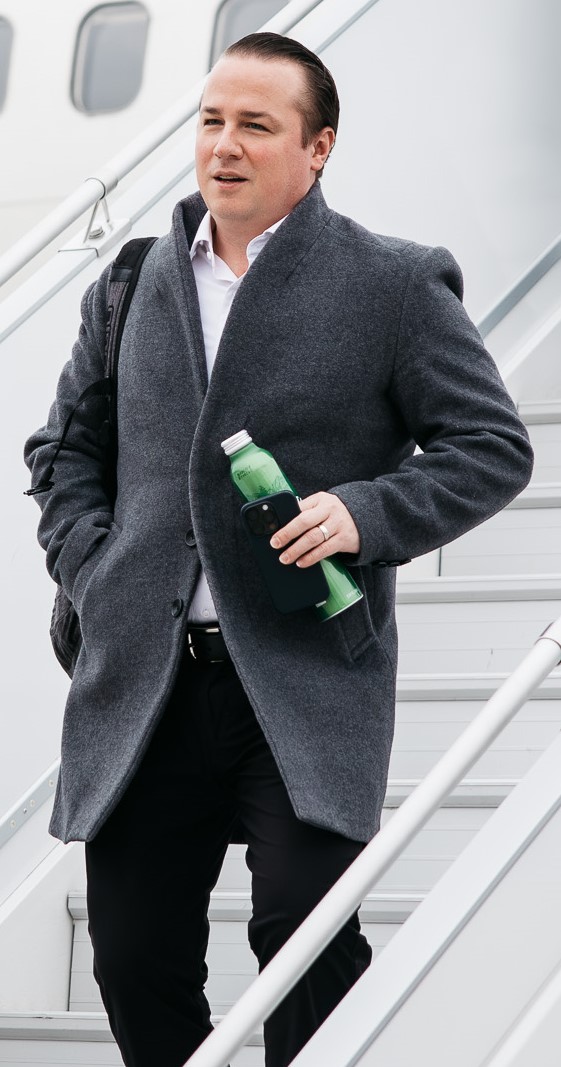 A man deplanes from an aircraft.