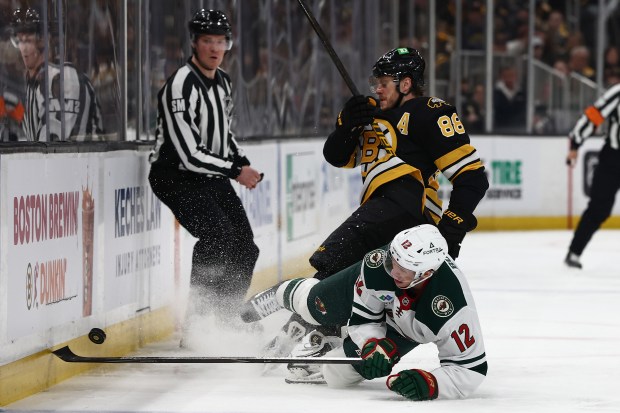 Minnesota Wild's Matt Boldy collides with Boston Bruins' David Pastrnak while going after a loose puck during the second period of an NHL hockey game Saturday, March 28, 2026, in Boston. (AP Photo/Winslow Townson)