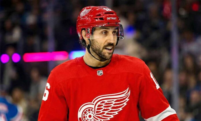 Photo illustration showing New York Rangers center Vincent Trocheck wearing a Detroit Red Wings jersey on the ice amid recent NHL trade rumors linking him to the team.